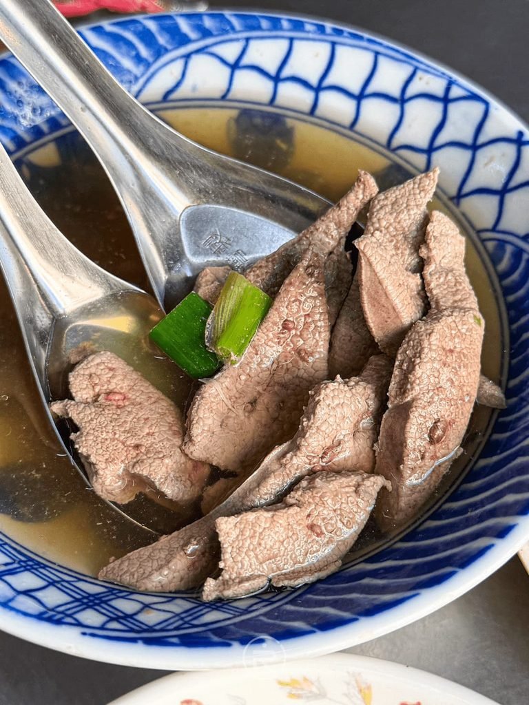 [大碗豬肝湯料多實在]： 藍白花紋碗中裝滿新鮮現煮的厚片豬肝與青蔥薑絲清湯。

