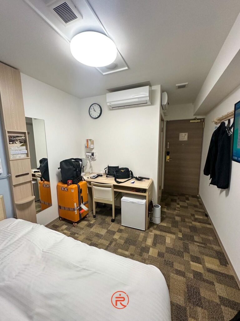  (書桌與設施)：東橫Inn客房辦公書桌與小冰箱設施，適合商務出差人士使用的收納空間"