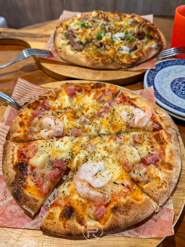澄品手工窯烤Pizza [雙口味披薩開吃]： 超級夏威夷披薩與客家鹹豬肉披薩雙拼全貌，色澤金黃誘人。