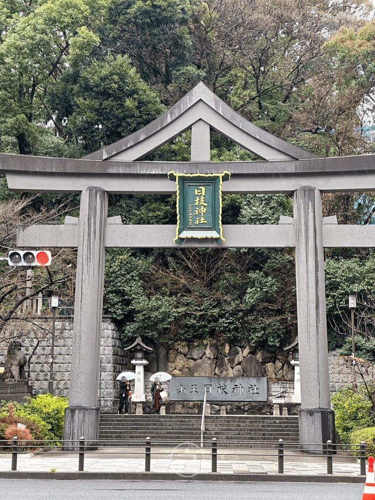 [街角入口全景]： 從街角遠眺日枝神社入口石階與山王鳥居，東京都市綠洲的入口。